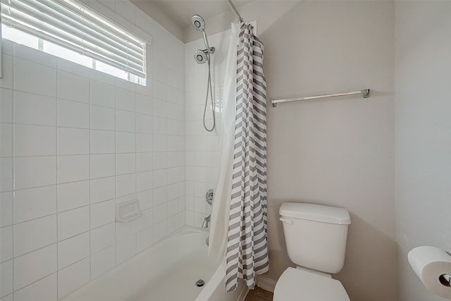 bathroom with shower / tub combo with curtain and toilet