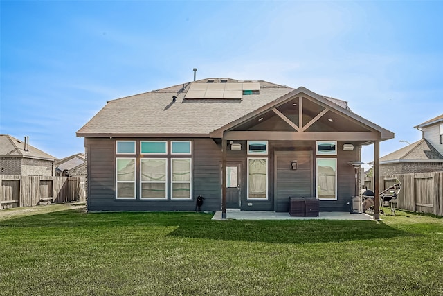 rear view of house with a lawn