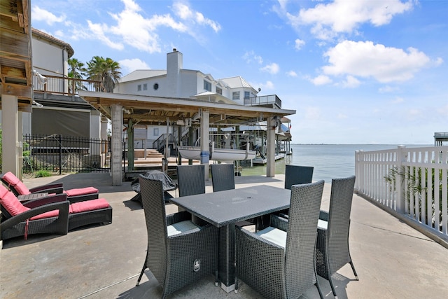 1239 Oahu Dr, Tiki Island, TX 77554 - view of patio / terrace with a water view, boat lift, and outdoor dining space