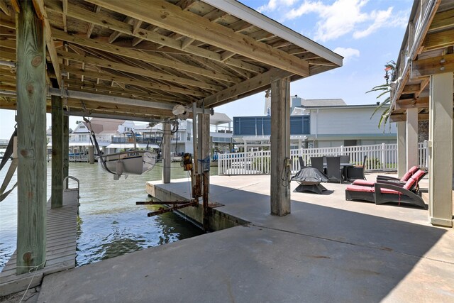 1239 Oahu Dr, Tiki Island, TX 77554 - dock featuring a water view and boat lift