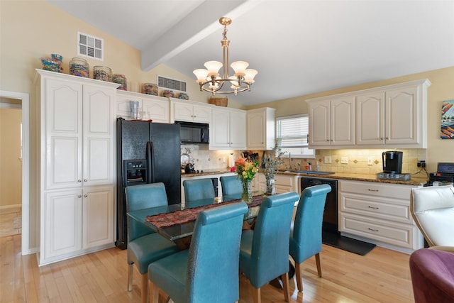 1239 Oahu Dr, Tiki Island, TX 77554 - kitchen with black appliances, a chandelier, white cabinets, and tasteful backsplash