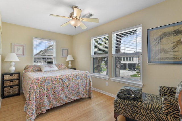 1239 Oahu Dr, Tiki Island, TX 77554 - bedroom featuring light wood-style floors, baseboards, and ceiling fan