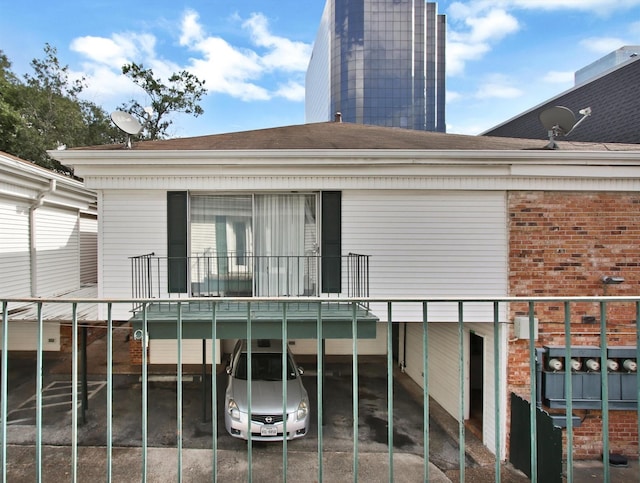 back of house with a balcony and a carport