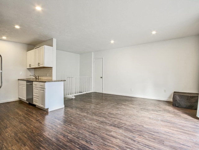 kitchen featuring dark wood-type flooring, white cabinets, dishwasher, sink, and backsplash