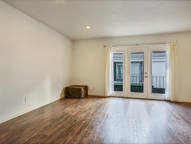 unfurnished room featuring french doors and wood-type flooring