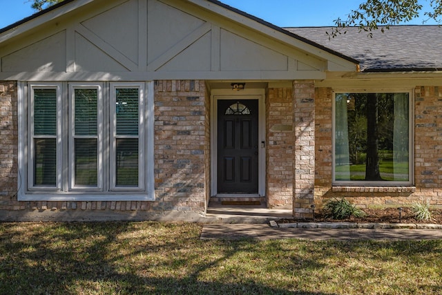 view of exterior entry with a lawn