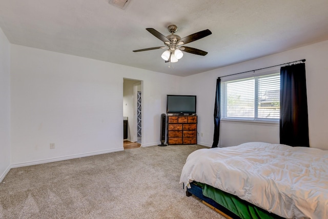 bedroom featuring ceiling fan and light carpet