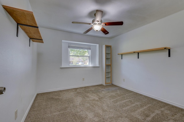 carpeted spare room with ceiling fan