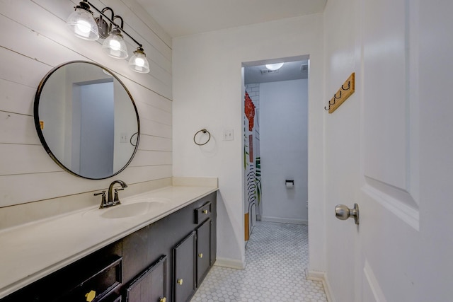 bathroom featuring vanity and wooden walls