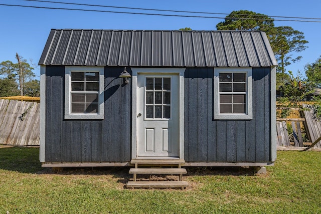 view of outbuilding featuring a lawn