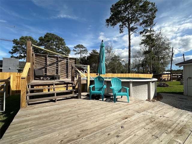 deck featuring a fenced in pool