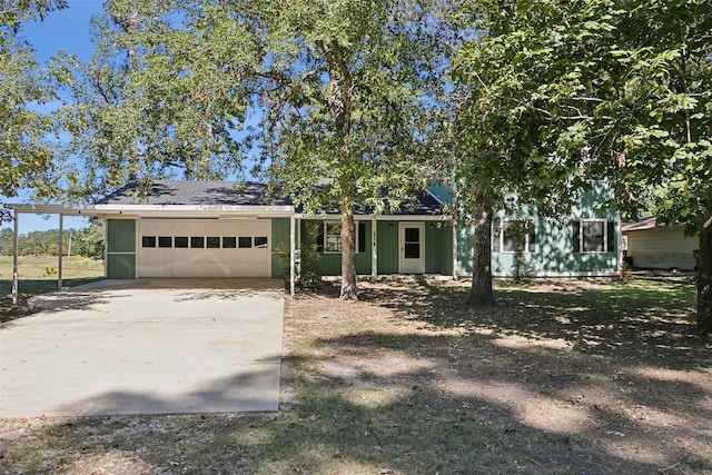 view of front of home with a garage and a carport