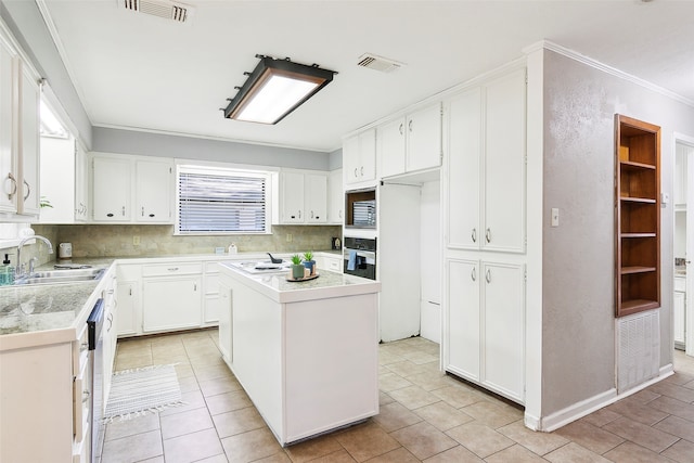 kitchen with sink, white cabinets, stainless steel appliances, and a kitchen island