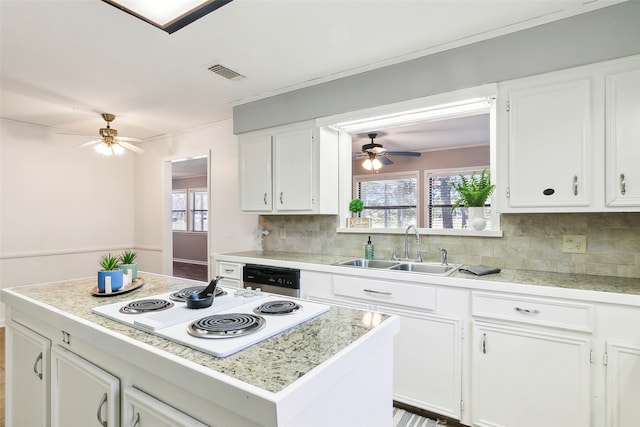 kitchen with sink, dishwasher, backsplash, a center island, and white electric stovetop