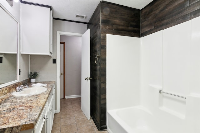 bathroom featuring vanity, a textured ceiling, and tile patterned floors