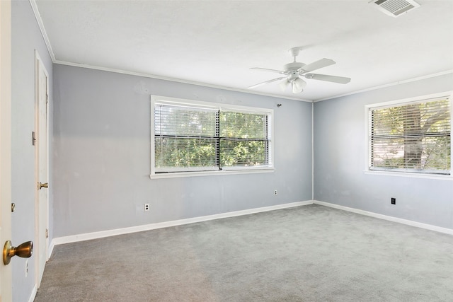 empty room with ornamental molding, carpet floors, and ceiling fan