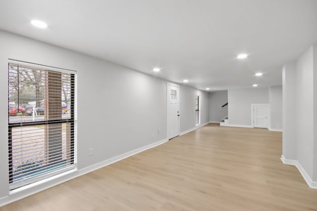 empty room with light hardwood / wood-style flooring