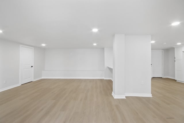 basement with light hardwood / wood-style flooring