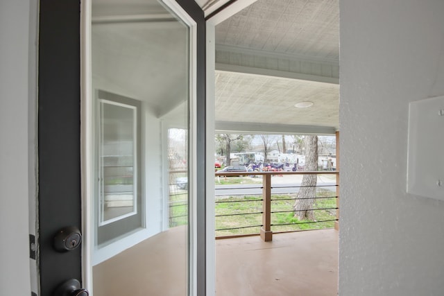 entryway featuring beam ceiling