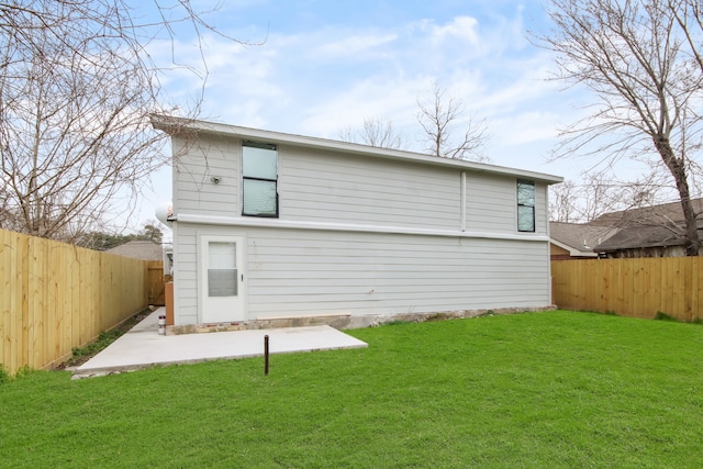 rear view of house with a patio area and a yard