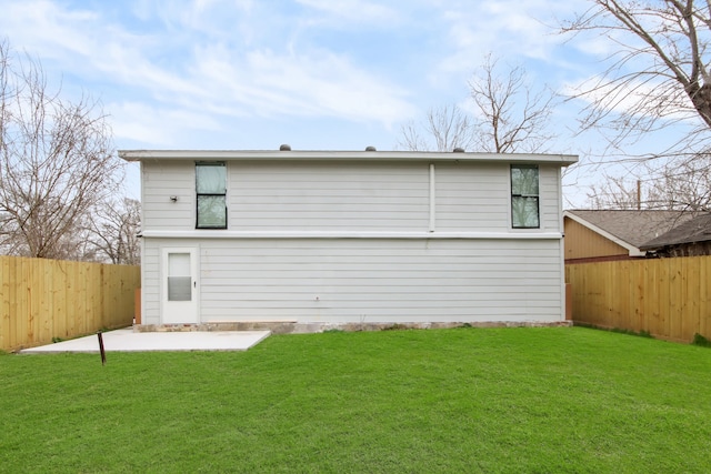 back of house with a yard and a patio area