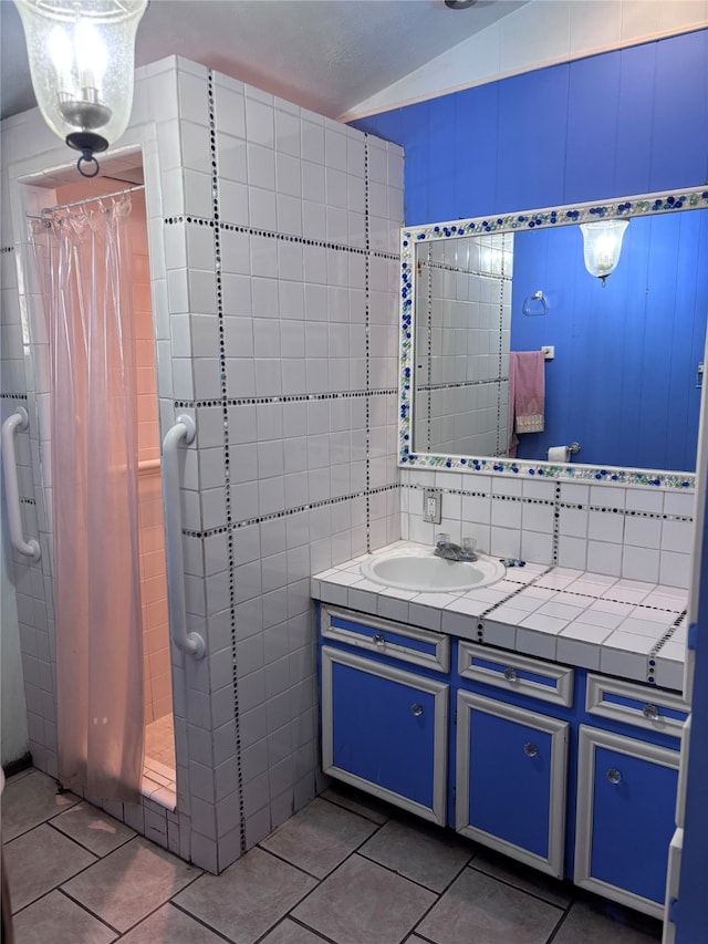 bathroom with tile patterned flooring, tile walls, vanity, and a shower with curtain