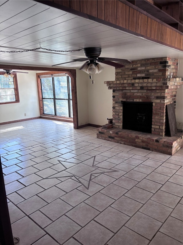 unfurnished living room with ceiling fan, a fireplace, and wooden ceiling