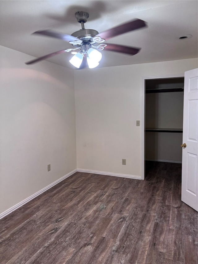 unfurnished bedroom with ceiling fan, a closet, and dark hardwood / wood-style flooring