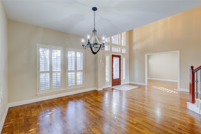 entryway featuring hardwood / wood-style floors and an inviting chandelier