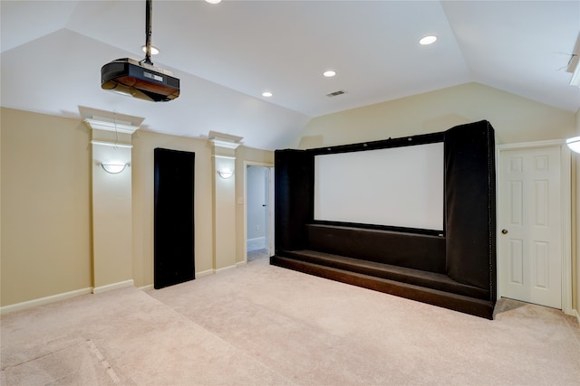 carpeted cinema with lofted ceiling