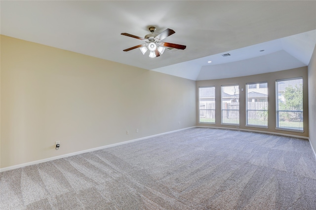 empty room with ceiling fan, lofted ceiling, and carpet floors