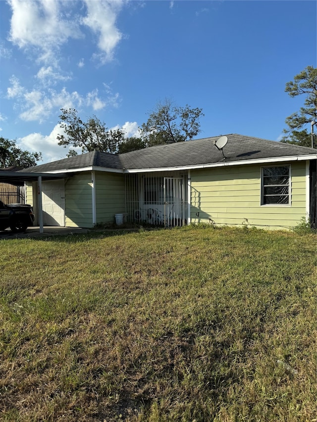 view of front of property with a front lawn and a carport