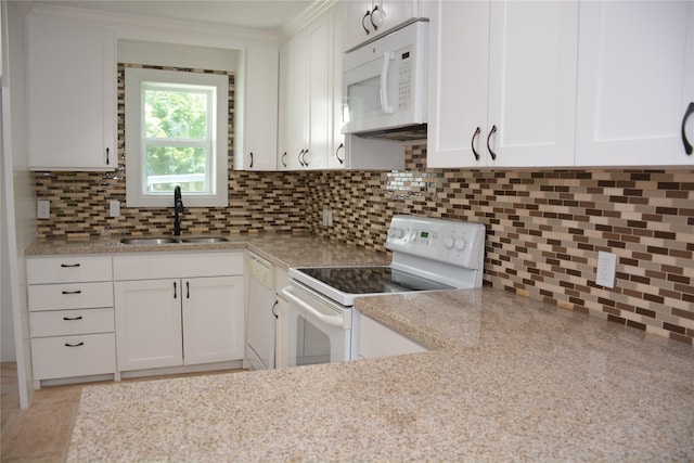 kitchen featuring backsplash, white appliances, sink, and white cabinets