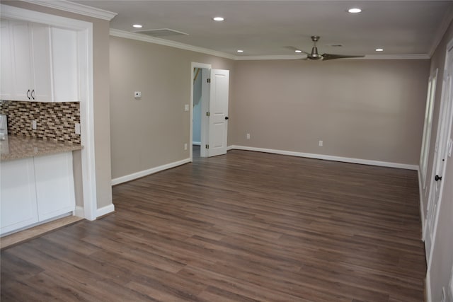 interior space featuring ornamental molding, ceiling fan, and dark wood-type flooring