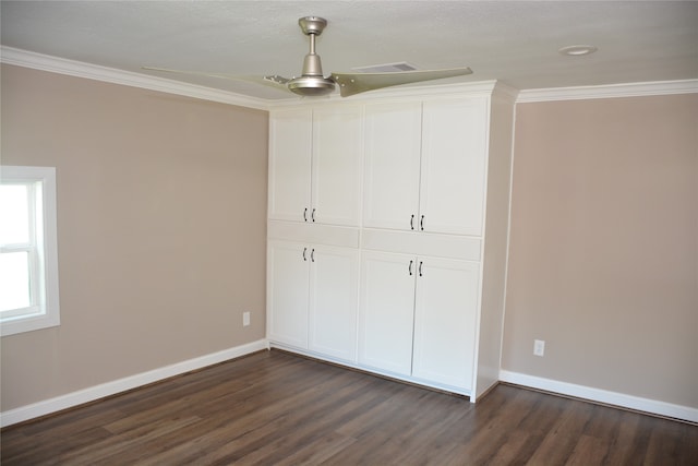 unfurnished bedroom featuring ceiling fan, ornamental molding, a closet, and dark wood-type flooring