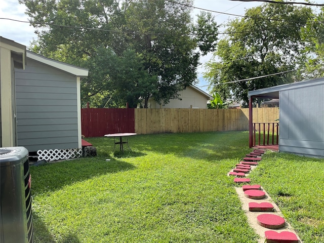 view of yard featuring central air condition unit