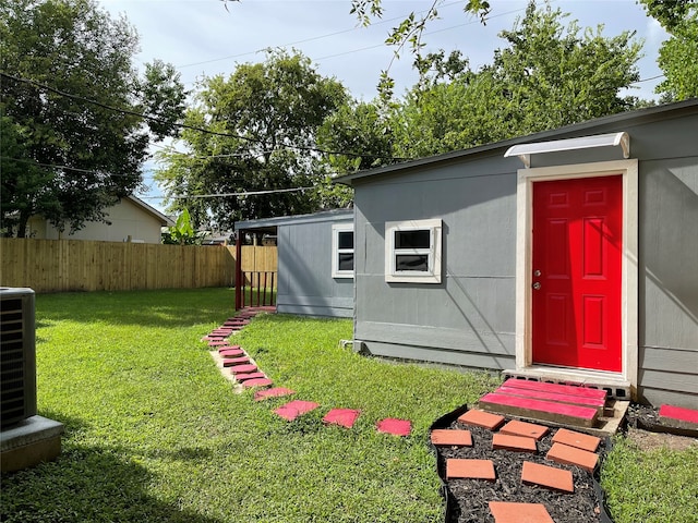 view of yard with central AC and an outdoor structure