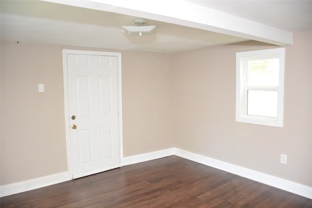 empty room with dark hardwood / wood-style flooring