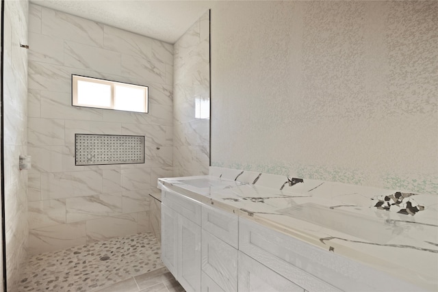 bathroom featuring a tile shower and tile patterned floors