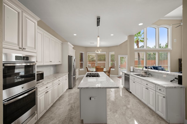 kitchen featuring appliances with stainless steel finishes, white cabinets, and a healthy amount of sunlight