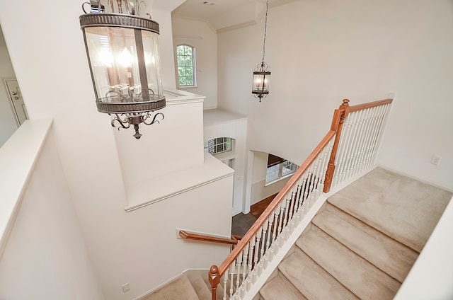 stairs featuring a notable chandelier and hardwood / wood-style floors