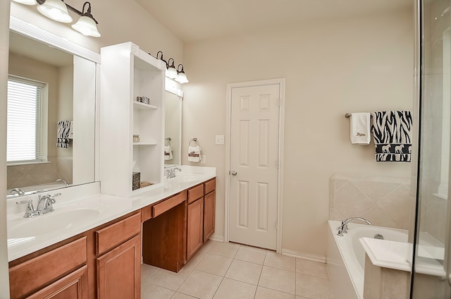 bathroom featuring tiled tub, tile patterned floors, and vanity