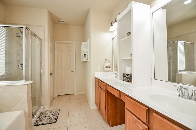 bathroom with tile patterned flooring, walk in shower, and vanity