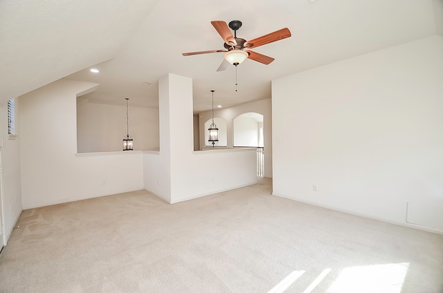 unfurnished living room featuring light carpet and ceiling fan