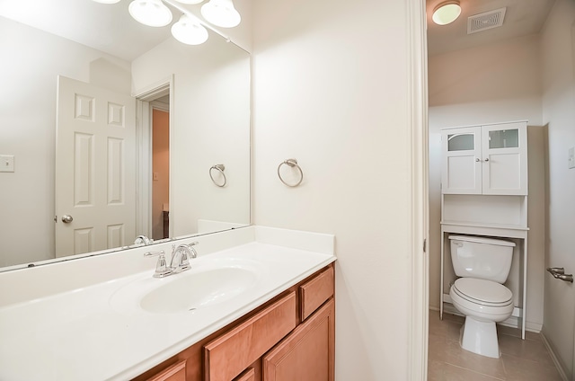 bathroom featuring vanity, tile patterned flooring, and toilet