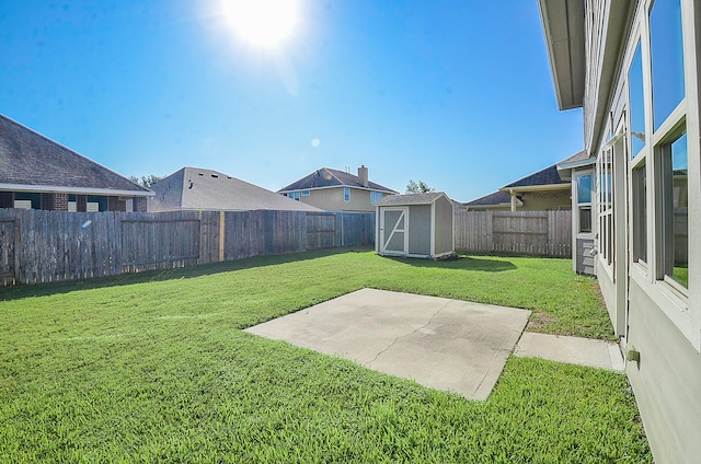 view of yard with a patio and a storage shed