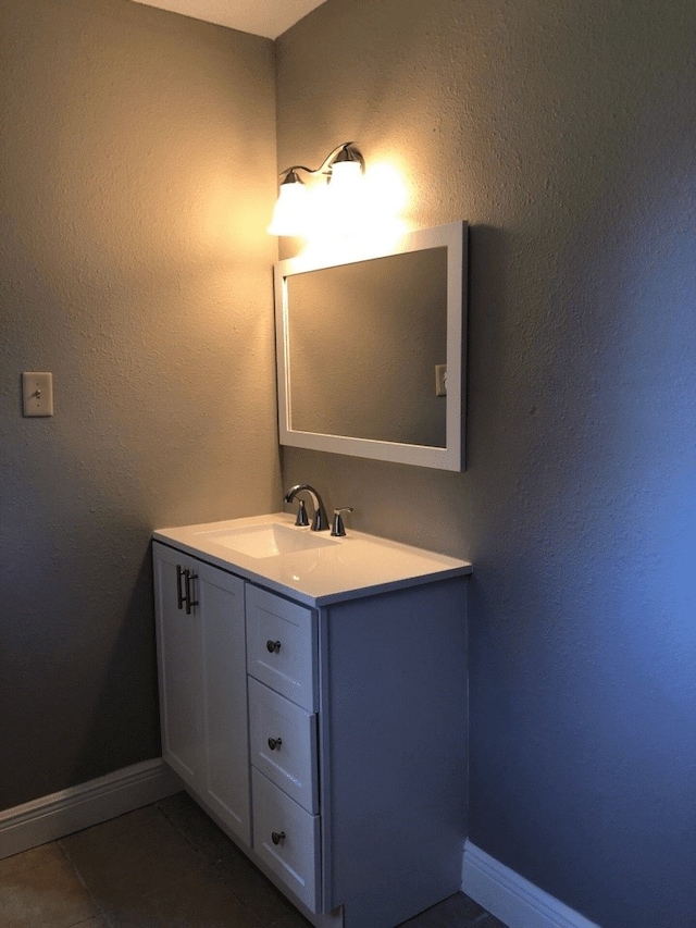 bathroom with tile patterned flooring and vanity