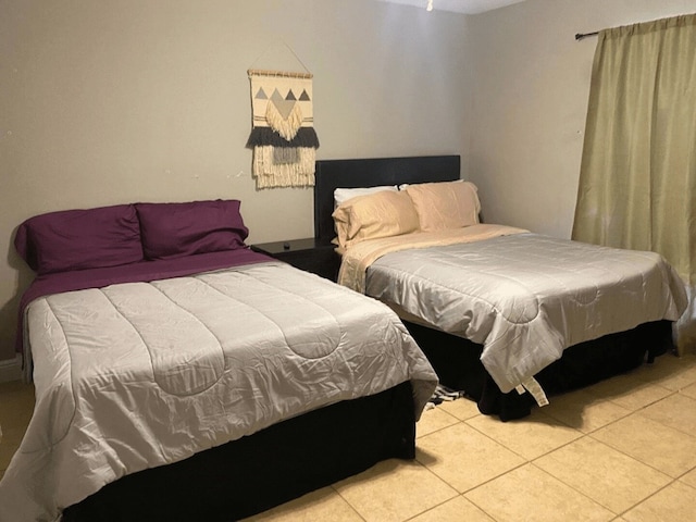 bedroom with light tile patterned floors