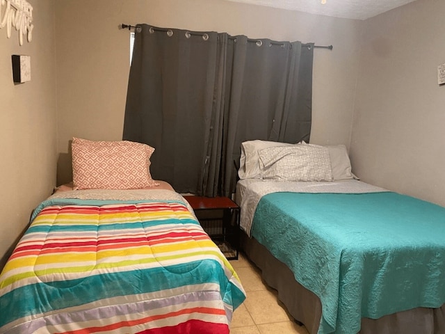 bedroom with light tile patterned flooring