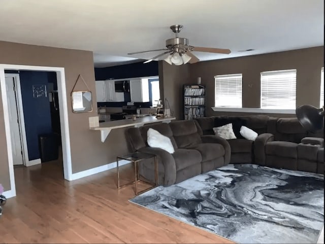 living room with ceiling fan and hardwood / wood-style floors